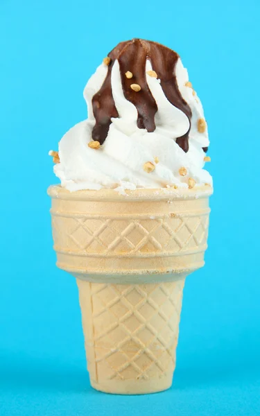 Tasty ice cream with chocolate, on blue background — Stock Photo, Image