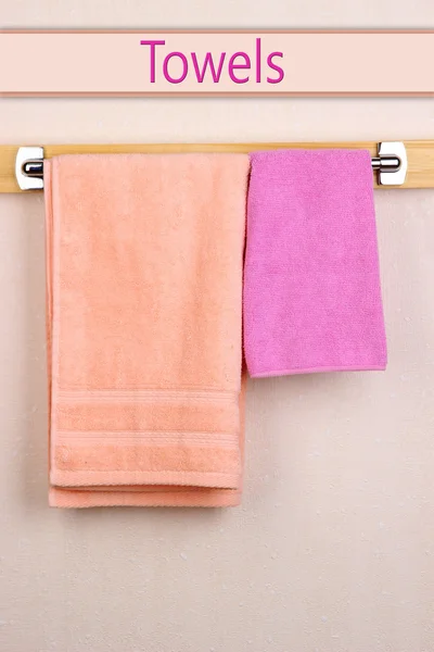 Bath towels on crossbar in room — Stock Photo, Image