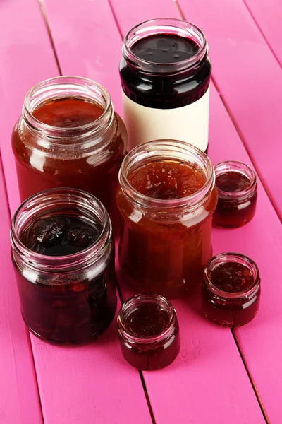 Tasty jam in banks on table — Stock Photo, Image