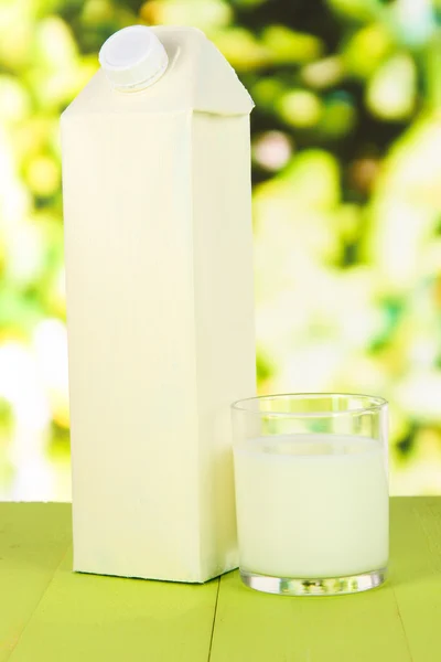 Milk pack on table on bright background — Stock Photo, Image