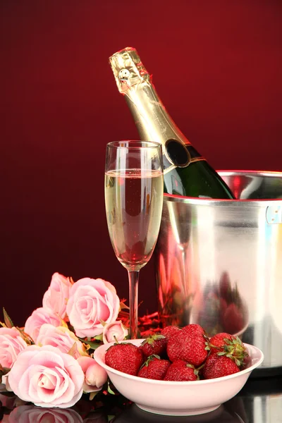 Romantic still life with champagne, strawberry and pink roses, on dark color background — Stock Photo, Image