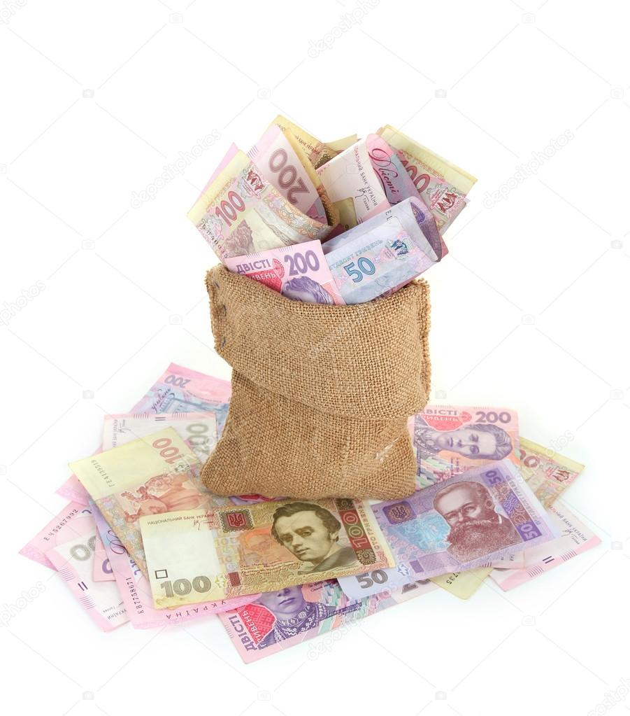 Burlap bag with Ukrainian money, isolated on white