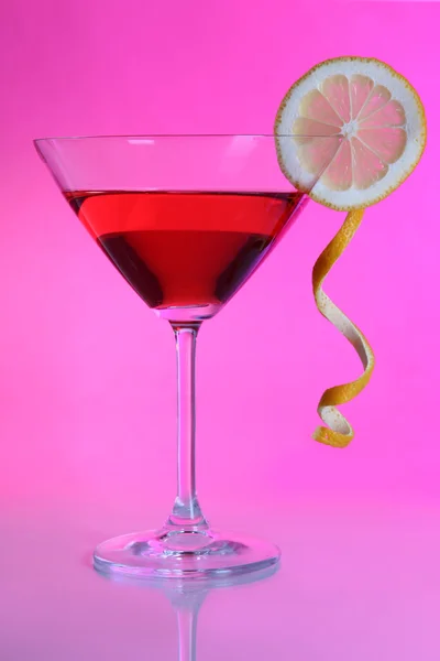 Red cocktail in martini glass on pink background — Stock Photo, Image