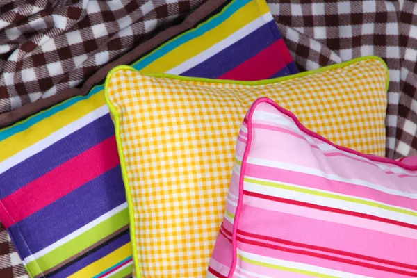 Three various pillows on plaid — Stock Photo, Image
