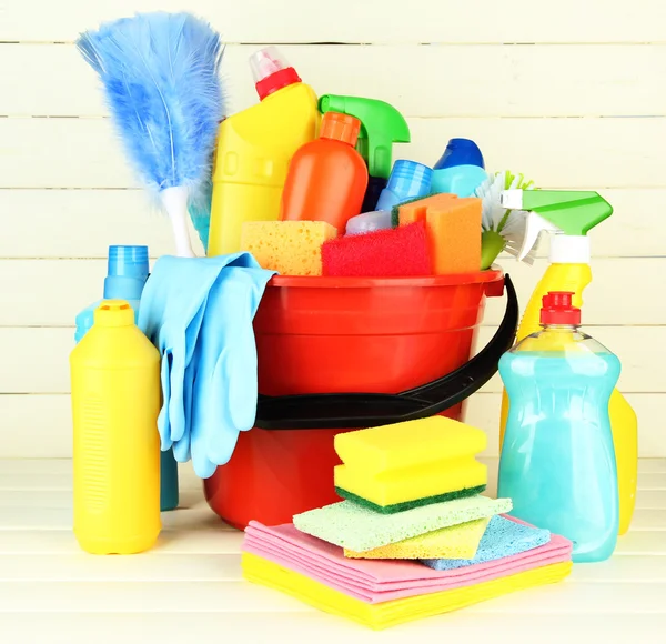 Cleaning items in bucket on white wooden background — Stock Photo, Image