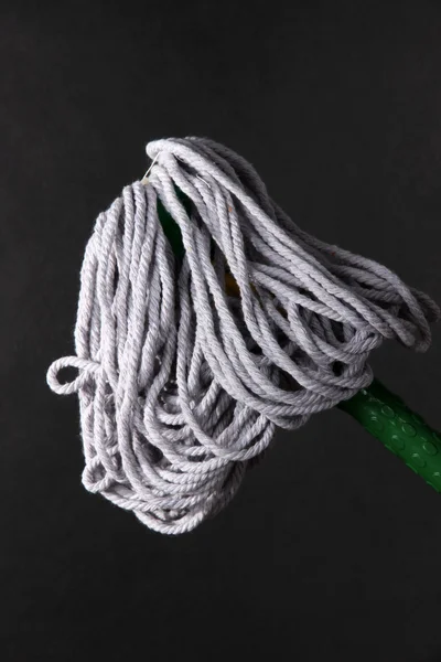 Mop for floor on dark background — Stock Photo, Image