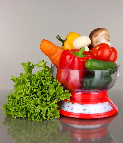 Fresh vegetables in scales on gray background — Stock Photo, Image