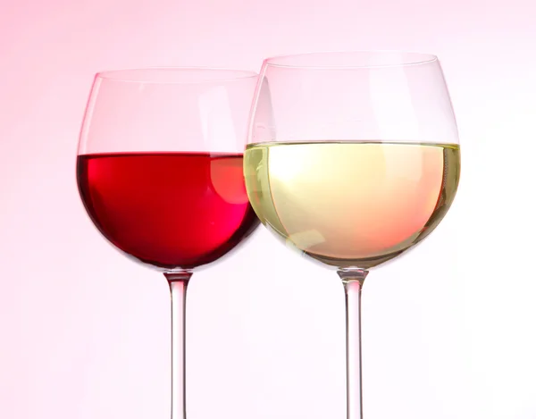 Glasses of wine on light pink tone — Stock Photo, Image