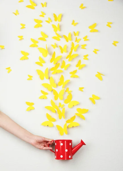 Paper yellow butterflies fly out of watering can — Stock Photo, Image