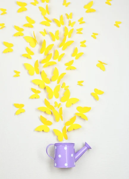 Paper yellow butterflies fly out of watering can — Stock Photo, Image