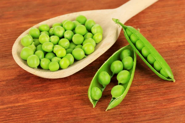Sweet green peas on wooden background — Stock Photo, Image