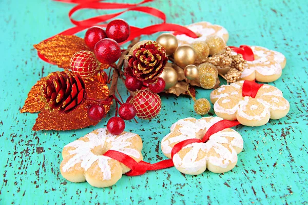 Christmas cookies and decorations on color wooden background — Stock Photo, Image