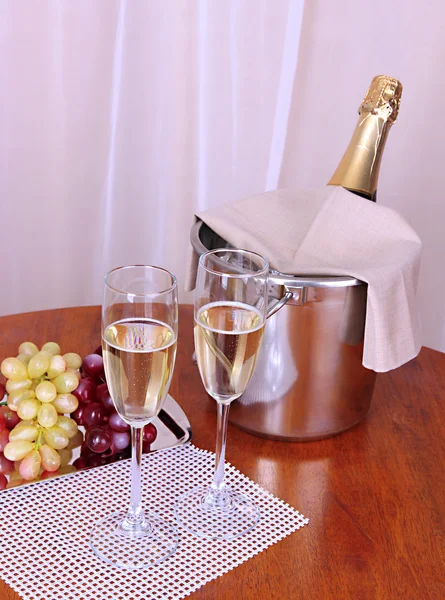 Champagne en bril op ronde tafel op doek achtergrond — Stockfoto