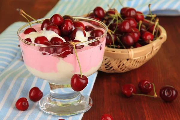 Delicious cherry dessert in glass vase on wooden table close-up — Stock Photo, Image