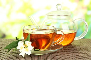 Yasemin, üzerinde parlak arka plan bambu hasır ile çay