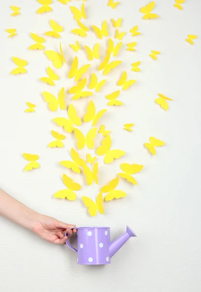 Paper yellow butterflies fly out of watering can — Stock Photo, Image