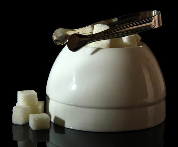 Raffinierter Zucker in weißer Zuckerdose auf schwarzem Hintergrund — Stockfoto