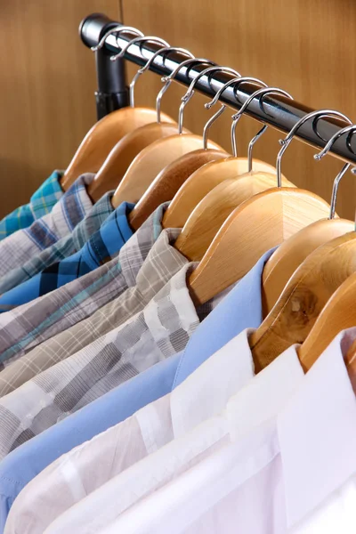 Men's shirts on hangers in wardrobe — Stock Photo, Image