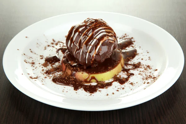 Chocolate dessert on big plate on wooden table — Stock Photo, Image