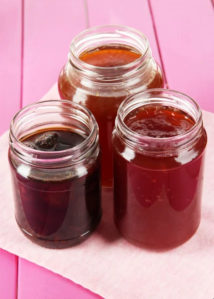 Tasty jam in banks on table — Stock Photo, Image