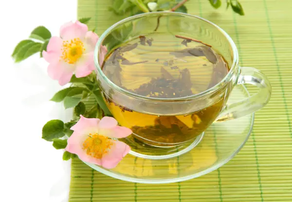 Cup of herbal tea with hip rose flowers, isolated on white — Stock Photo, Image