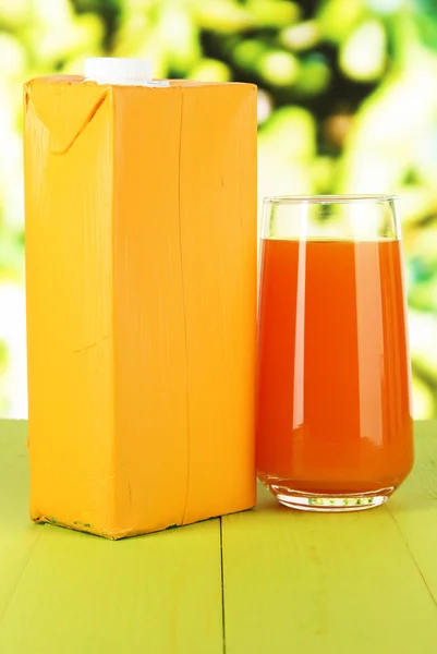 Juice pack on table on bright background — Stock Photo, Image