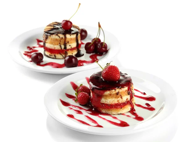 Tasty biscuit cakes with jam and berries on plates, isolated on white — Stock Photo, Image