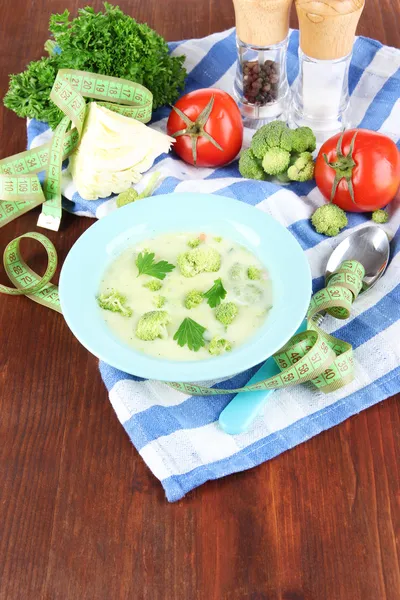 Cabbage soup in plates on napkin on wooden table — Stock Photo, Image