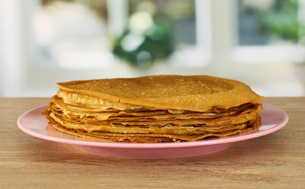 Sweet pancakes on plate on table in kitchen — Stock Photo, Image