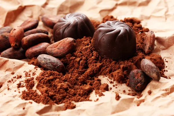 Suklaamakeisten ja kaakaon koostumus ruskealla pohjalla — kuvapankkivalokuva