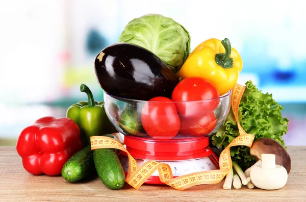 Fresh vegetables in scales on table in kitchen — Stock Photo, Image