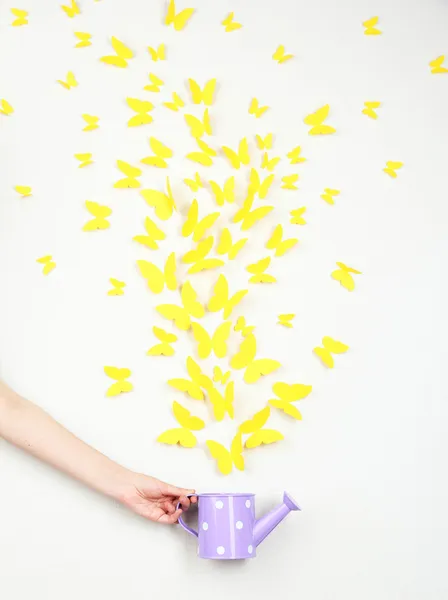 Paper yellow butterflies fly out of watering can — Stock Photo, Image