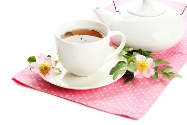 Cup and teapot of herbal tea with hip rose flowers, isolated on white — Stock Photo, Image