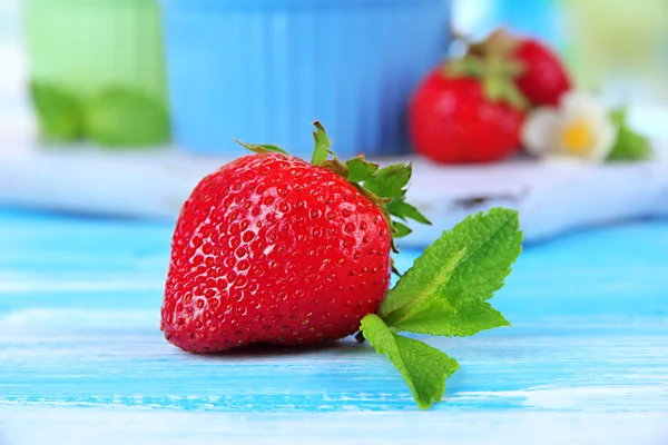 Ripe sweet strawberry on blue wooden table — Stock Photo, Image