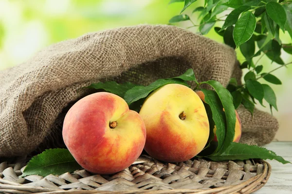 Ripe sweet peaches on wooden table in garden, close up — Stock Photo, Image