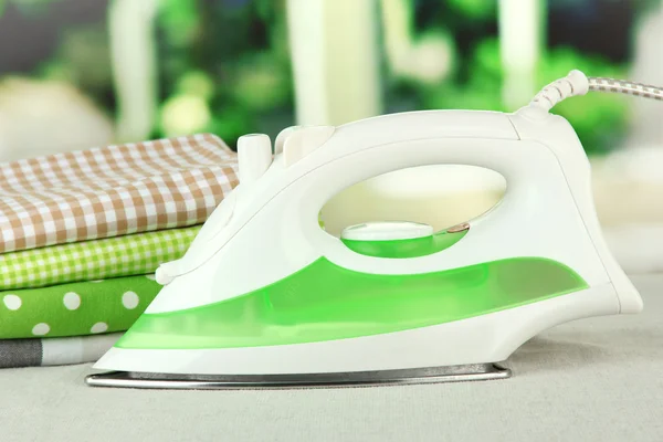 Steam iron on bright background — Stock Photo, Image