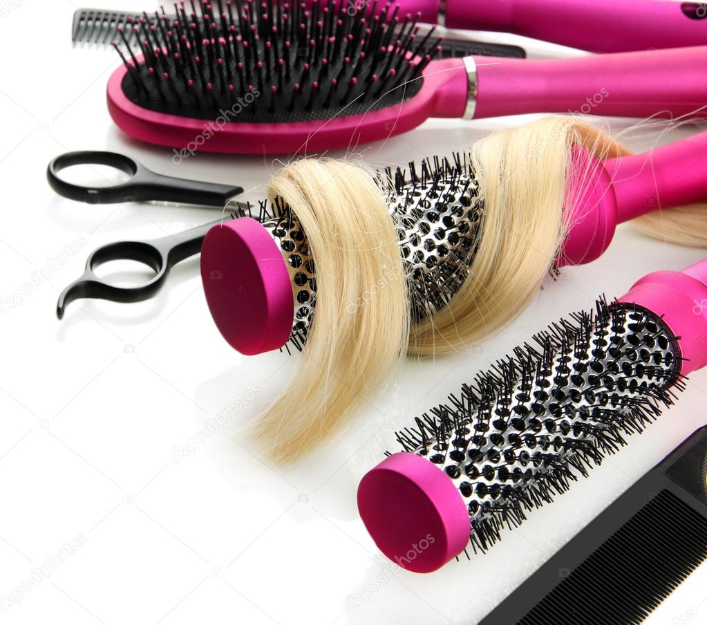 Comb brushes, hair and cutting shears, isolated on white Stock Photo by