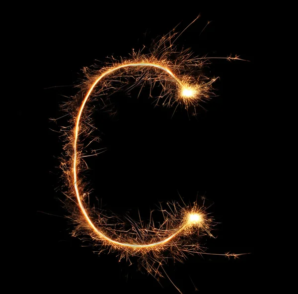 Letter "C" sparklers on black background — Stock Photo, Image