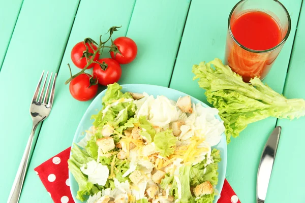 Caesarsalade op blauw bord, op een houten achtergrond kleur — Stockfoto