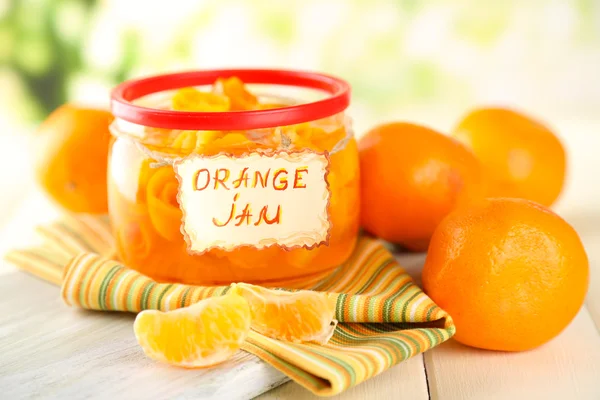 Orange jam with zest and tangerines, on white wooden table — Stock Photo, Image