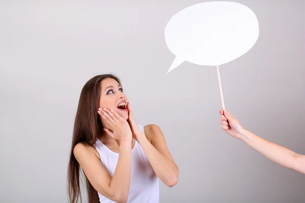 Young pretty woman with empty think bubble on grey background — Stock Photo, Image