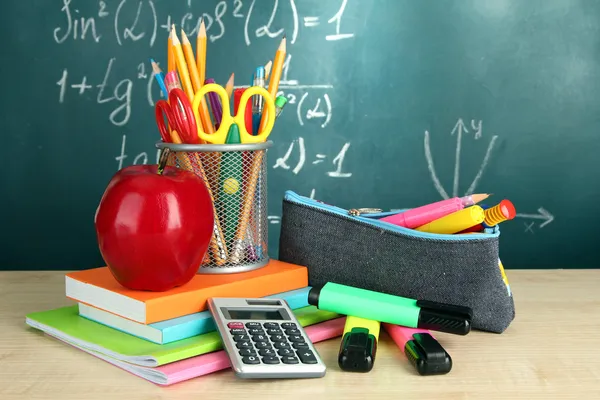 Back to school - blackboard with pencil-box and school equipment on table — Stock Photo, Image
