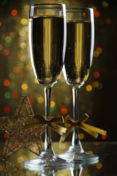 Two glasses of champagne on bright background with lights — Stock Photo, Image