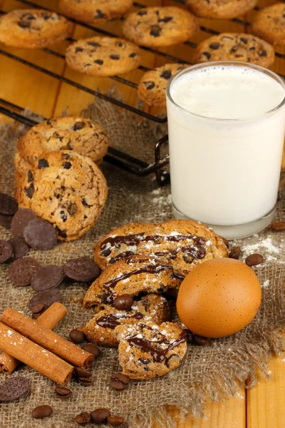Chocolate cookies on the baking with glass of milk close up — Stock Photo, Image