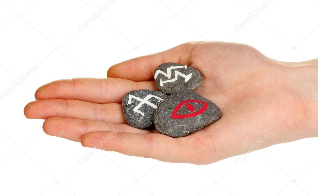 Fortune telling with symbols on stone in hand isolated on white