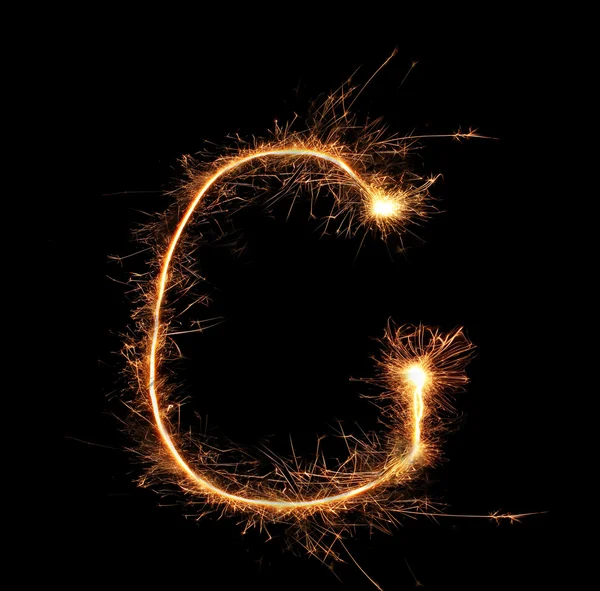 Letter "G" sparklers on black background — Stock Photo, Image