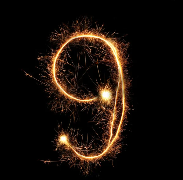 Number "nine" sparklers on black background — Stock Photo, Image
