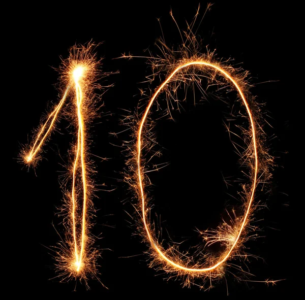 Number "ten" sparklers on black background — Stock Photo, Image