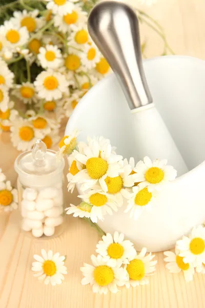 Medicine chamomile flowers on wooden table — Stock Photo, Image