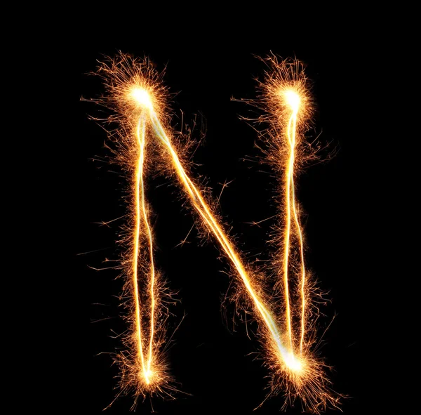 Letter "N" sparklers on black background — Stock Photo, Image